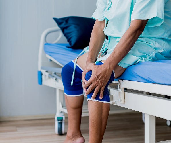 A clinical examination of a patient with medial compartment knee osteoarthritis, showing a "bowed" leg alignment suitable for an unloader brace.