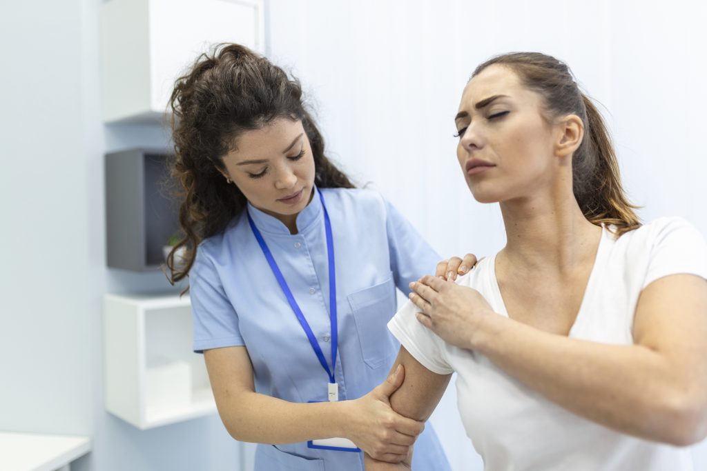 Doctor examining a patient’s shoulder with treatment options like PRP therapy and injections highlighted.