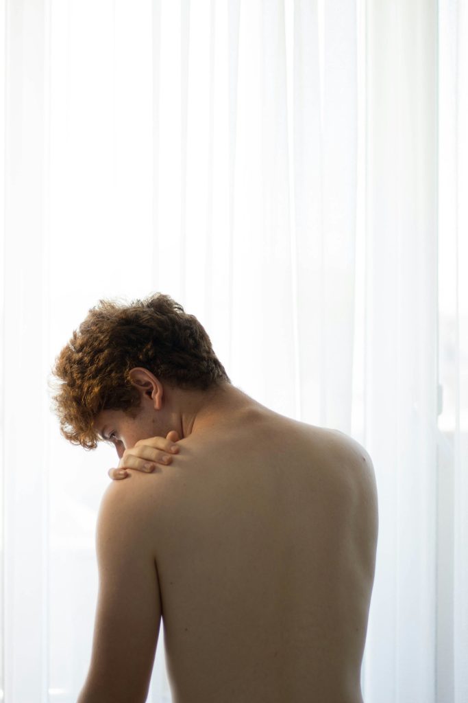 Person experiencing shoulder pain and stiffness