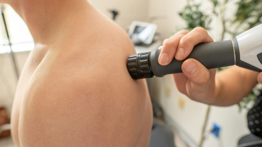 Shoulder pain specialist evaluating patient shoulder