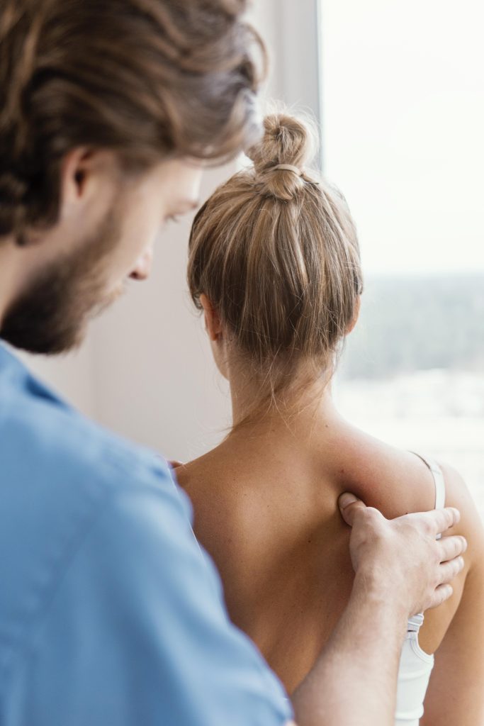 Provider examining shoulder pain causes in Concord, NC