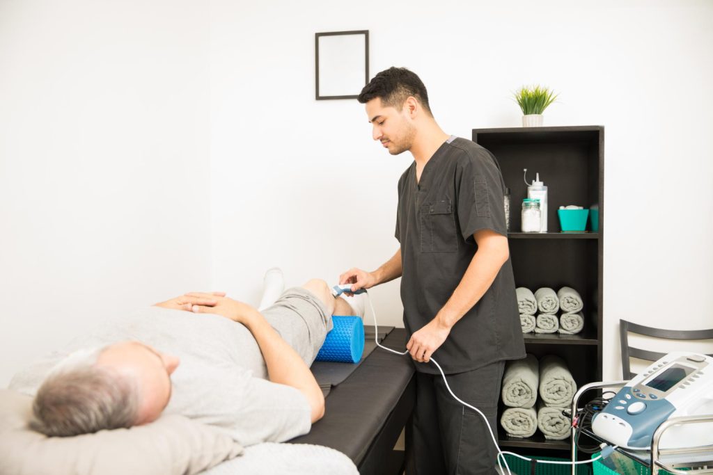 Healthcare professional supporting a patient during non-surgical knee care