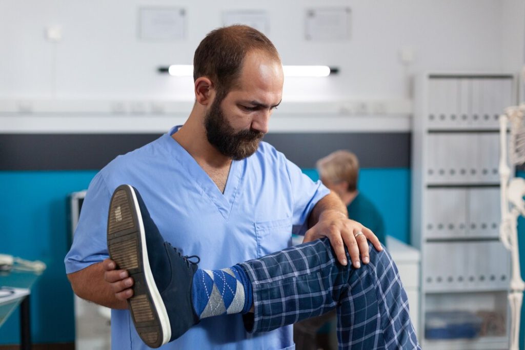 Healthcare professional supporting a patient during non-surgical knee care