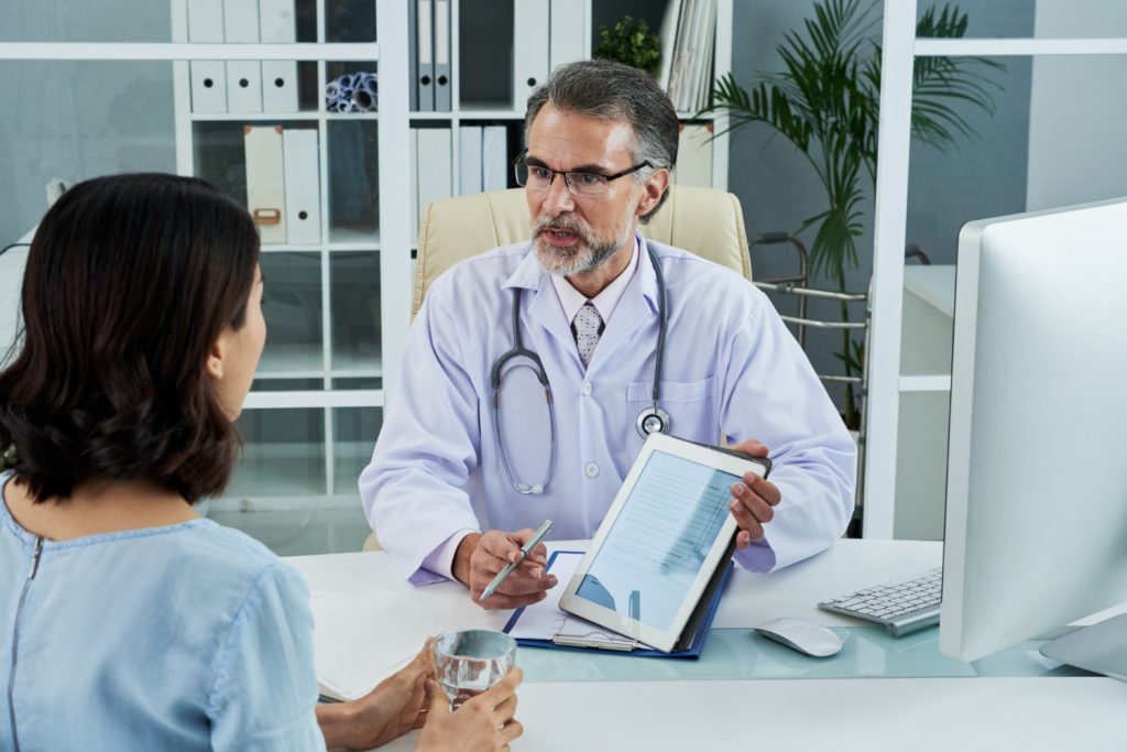 Medical provider discussing a personalized joint treatment plan with a patient from Huntersville NC