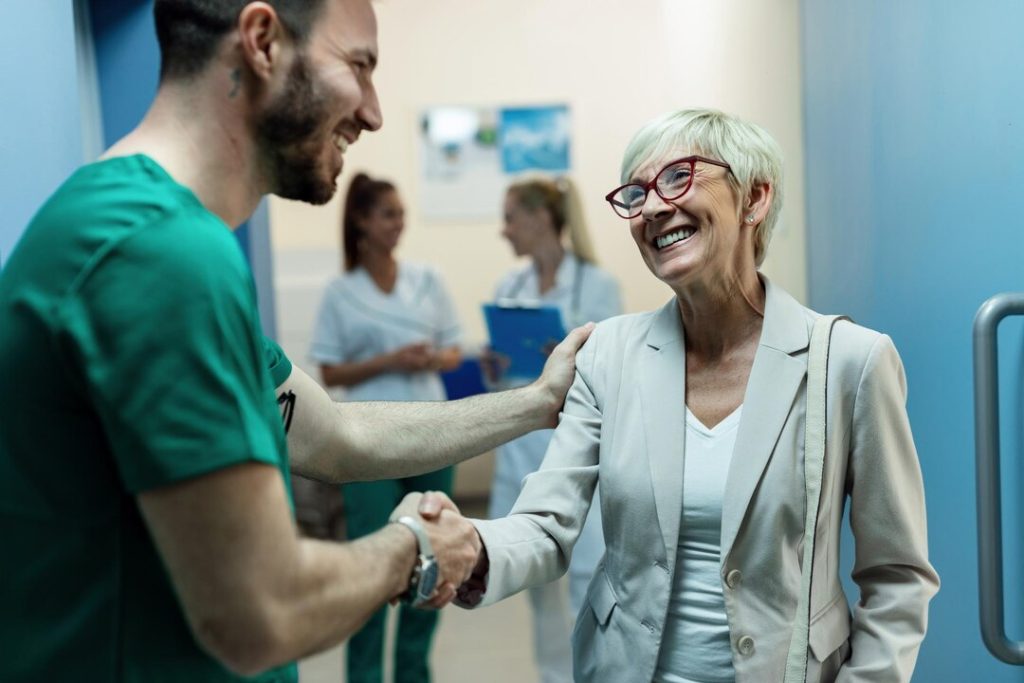 Patient greeting a healthcare professional during a clinic consultation