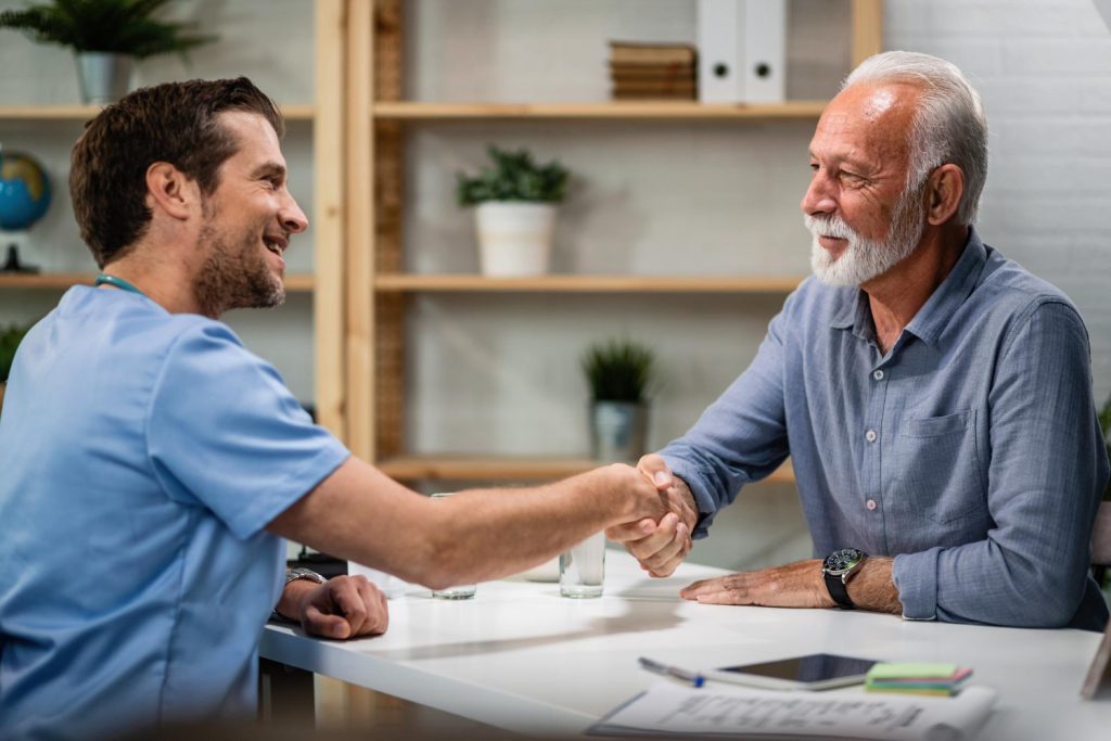 Healthcare professional greeting an older patient receiving joint care near Huntersville NC