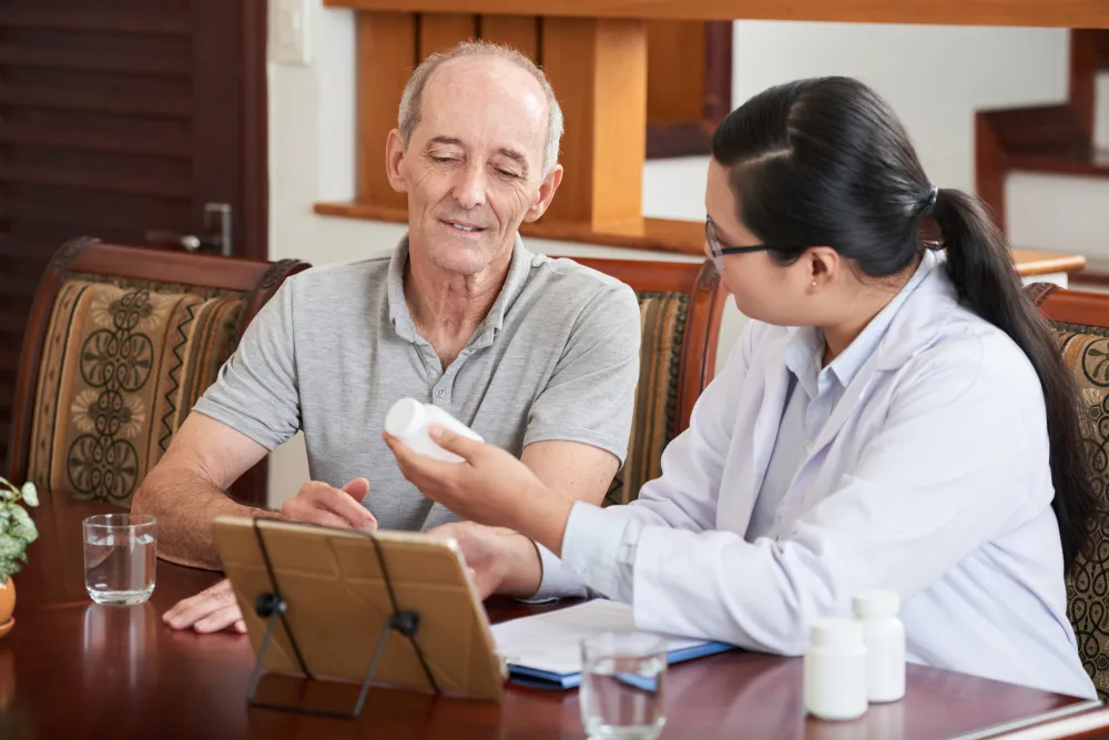 Healthcare professional explaining joint care to an older patient near Concord NC
