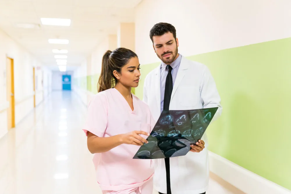 Medical provider reviewing a joint image with a patient from Huntersville NC