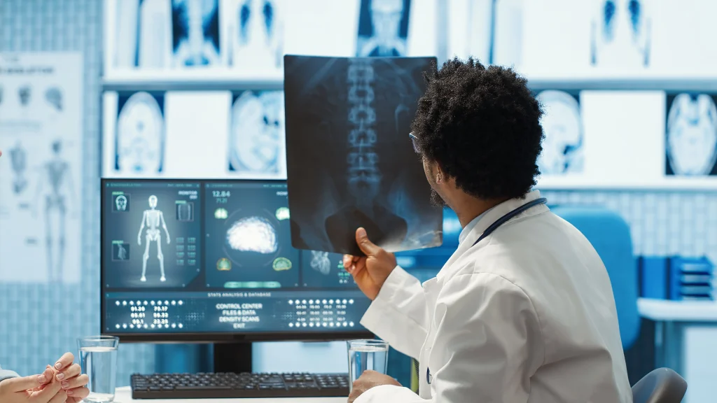 Medical provider reviewing a joint image with a patient from Mint Hill NC