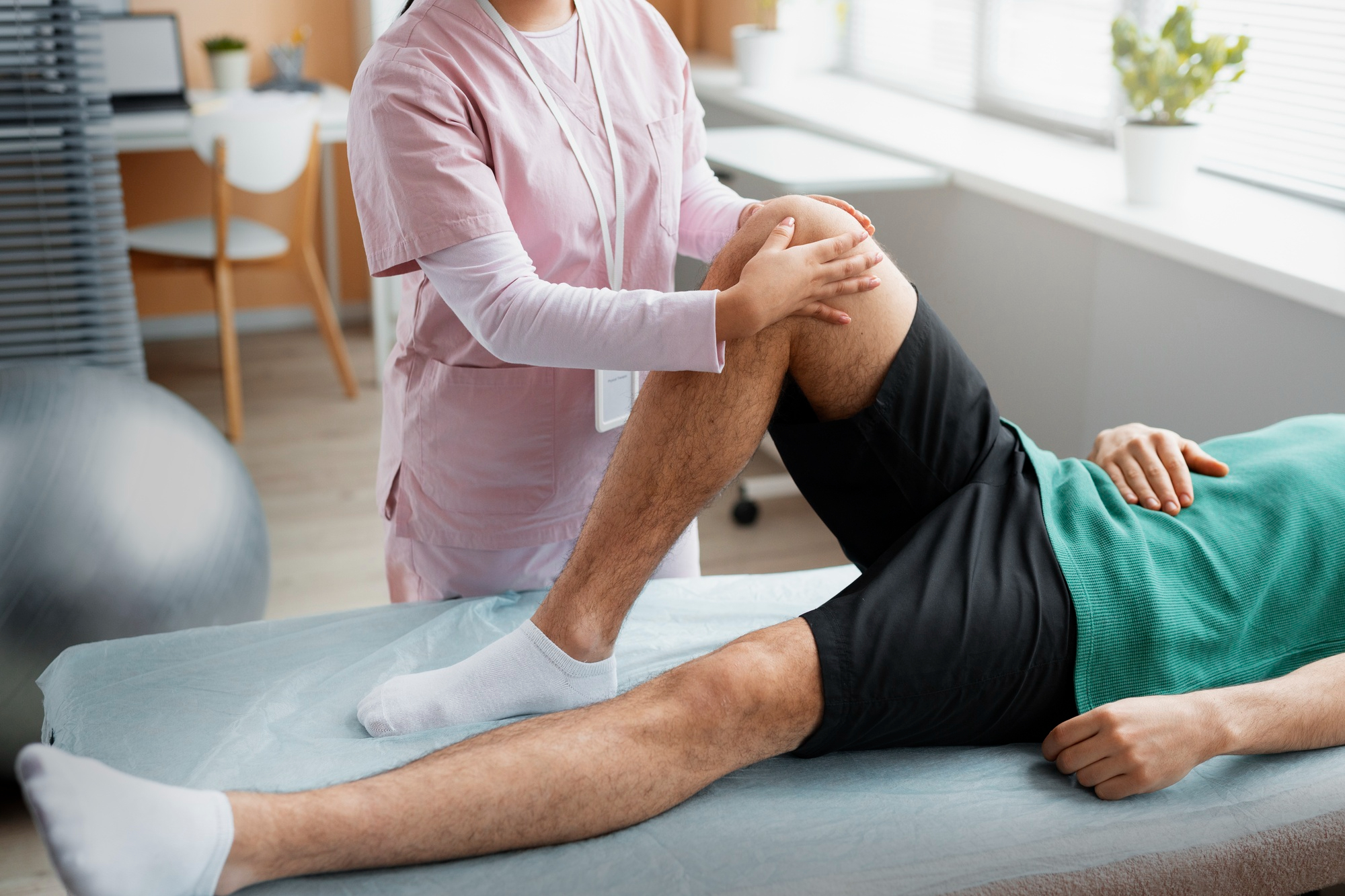 Healthcare professional supporting a patient during non-surgical knee care