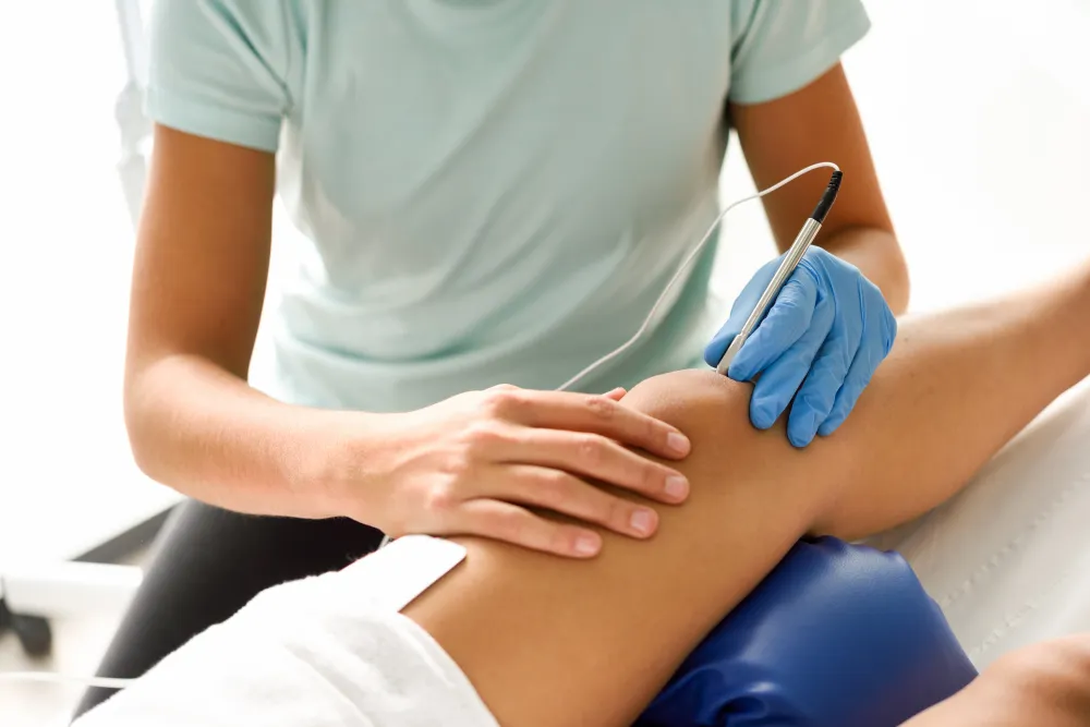 Healthcare professional supporting a patient during non-surgical knee care