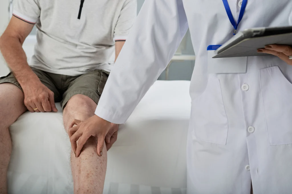 Healthcare professional supporting a patient during non-surgical knee care
