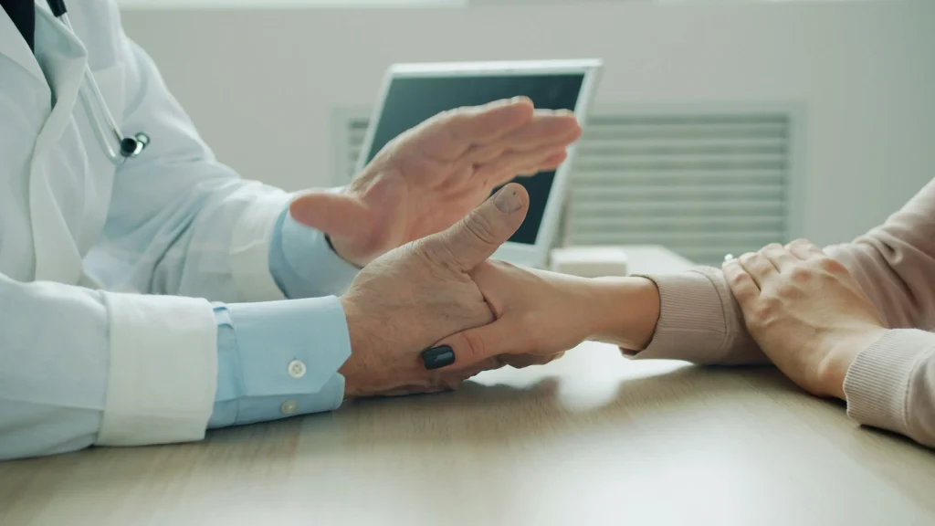 Patient greeting a healthcare professional during a clinic consultation