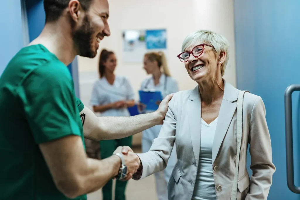 Healthcare professional greeting an older patient receiving joint care near Huntersville NC