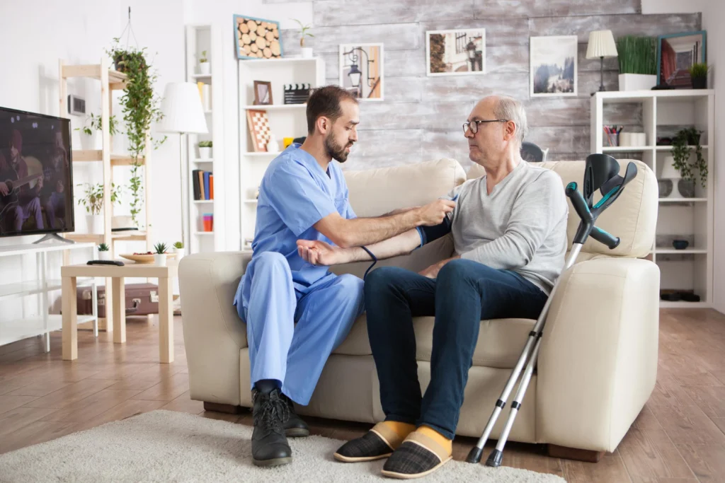 Healthcare professional greeting an older patient during a clinic consultation