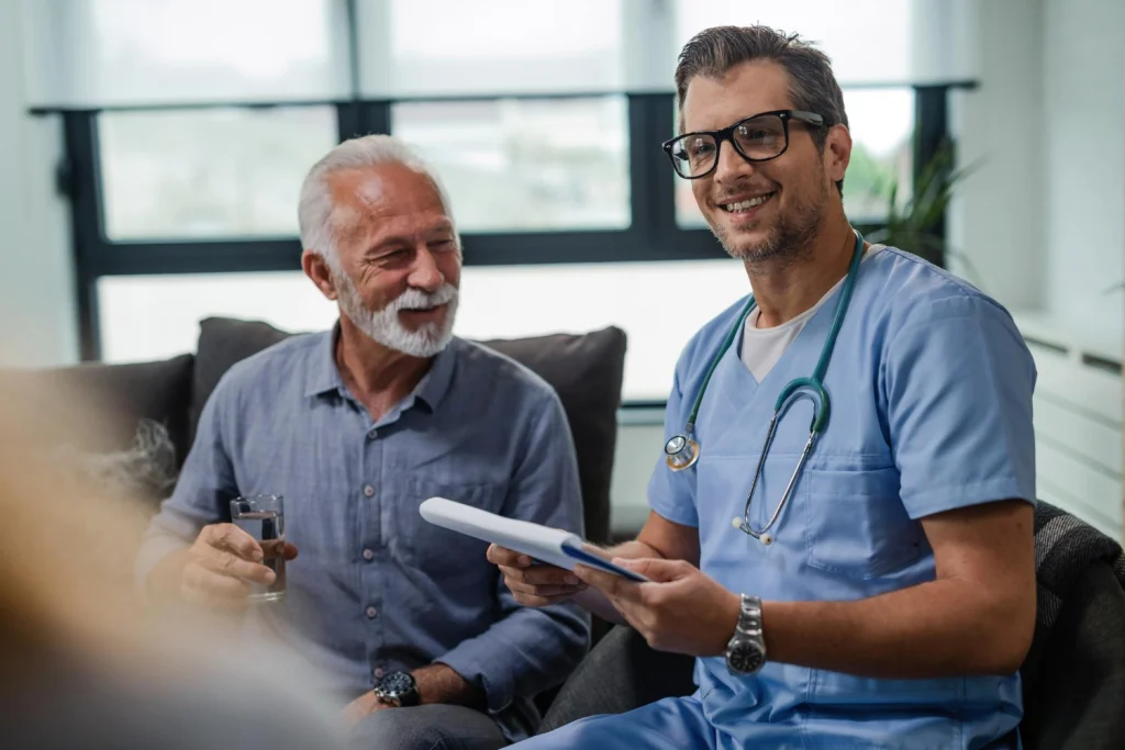 Healthcare professional greeting an older patient during a clinic visit