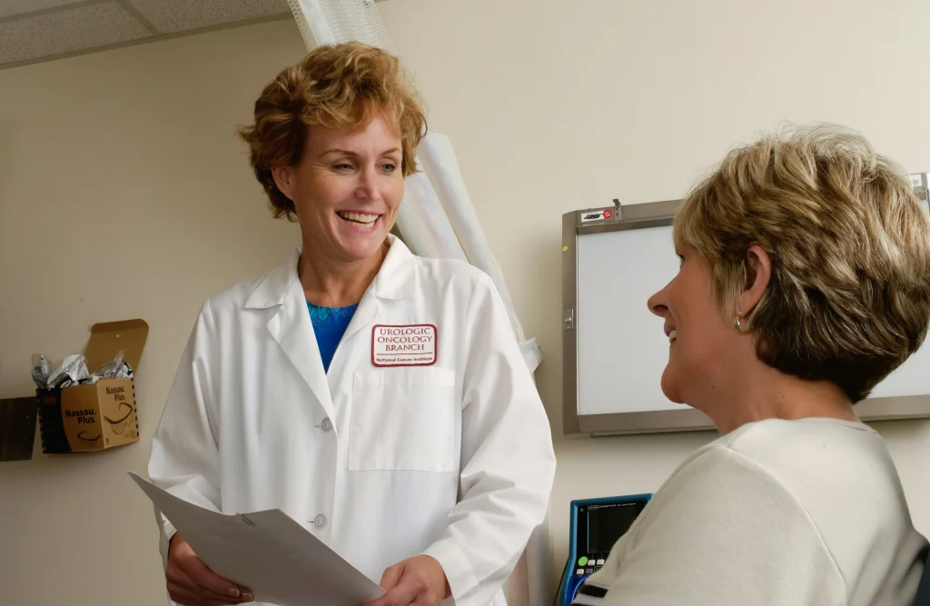 Healthcare professional greeting an older patient during a clinic consultation